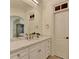 Main bathroom features double vanity with marble countertop and neutral decor at 8230 Royal Melbourne Way, Duluth, GA 30097