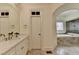 Main bathroom features double vanity with marble countertop, soaking tub and neutral decor at 8230 Royal Melbourne Way, Duluth, GA 30097