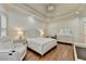 Spacious bedroom featuring tray ceiling, hardwood floors and neutral decor at 8230 Royal Melbourne Way, Duluth, GA 30097