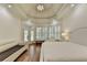 Luxurious bedroom with tray ceiling, hardwood floors, shutters, and sitting area at 8230 Royal Melbourne Way, Duluth, GA 30097