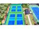 Overhead view of modern pickleball courts with shaded seating, perfect for outdoor recreation and community engagement at 8230 Royal Melbourne Way, Duluth, GA 30097