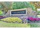 Stone entrance sign displaying the 'St Marlo Country Club' name, with vibrant floral landscaping, welcoming all at 8230 Royal Melbourne Way, Duluth, GA 30097