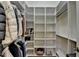 Organized walk-in closet with custom shelving and hanging rods for optimal storage and convenience at 8230 Royal Melbourne Way, Duluth, GA 30097