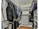 Walk-in closet featuring custom shelving, drawers, hanging racks and hardwood floors at 8230 Royal Melbourne Way, Duluth, GA 30097