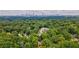 Beautiful home nestled amongst lush trees with city skyline in background at 91 Rogers Se St, Atlanta, GA 30317
