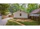 The home's backyard has a mulched planting area and a convenient driveway leading to the garage at 91 Rogers Se St, Atlanta, GA 30317
