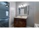 Neutral bathroom featuring a single sink vanity with a wood cabinet and a mirror with a chrome frame at 91 Rogers Se St, Atlanta, GA 30317