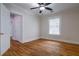 Bedroom with wood floor, a ceiling fan, a closet, and a window with blinds at 91 Rogers Se St, Atlanta, GA 30317