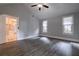 Bedroom with gray laminate floors and two windows, seamlessly connects to the kitchen through a doorway at 91 Rogers Se St, Atlanta, GA 30317