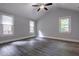Bedroom featuring gray laminate flooring, vaulted ceilings, and three windows offering natural light at 91 Rogers Se St, Atlanta, GA 30317