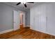 Charming bedroom featuring wood floors, a ceiling fan, and built-in storage cabinets at 91 Rogers Se St, Atlanta, GA 30317