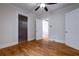 Bedroom with wood floors, ceiling fan, and multiple doors leading to other rooms at 91 Rogers Se St, Atlanta, GA 30317