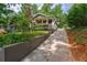 Charming home with a welcoming front porch and well-manicured landscaping along a sloping driveway at 91 Rogers Se St, Atlanta, GA 30317