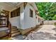 Side view of a white, cottage-style home with wooden accents and a concrete driveway at 91 Rogers Se St, Atlanta, GA 30317
