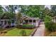 Quaint home with lush landscaping, a driveway and a welcoming front porch at 91 Rogers Se St, Atlanta, GA 30317