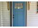 Close-up of a craftsman-style blue front door with glass pane, contrasted against white siding at 91 Rogers Se St, Atlanta, GA 30317