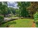 Well-maintained front yard with lush green lawn and mature trees, enhancing curb appeal at 91 Rogers Se St, Atlanta, GA 30317