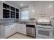 Well-lit kitchen featuring white cabinets, stainless steel appliances, and neutral countertops at 91 Rogers Se St, Atlanta, GA 30317