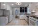 Bright kitchen with white cabinetry, stainless steel appliances, and tile flooring at 91 Rogers Se St, Atlanta, GA 30317