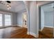 Open-concept living room featuring hardwood floors, arched doorway, and light gray walls at 91 Rogers Se St, Atlanta, GA 30317