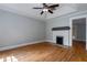 Comfortable living room with a brick fireplace, hardwood flooring, and ceiling fan at 91 Rogers Se St, Atlanta, GA 30317
