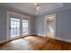 Bright living room with French doors leading to a balcony, complemented by hardwood floors at 91 Rogers Se St, Atlanta, GA 30317