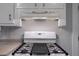 Close up of a white stove top and overhead vent in a gray kitchen at 91 Rogers Se St, Atlanta, GA 30317