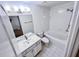 Well-lit bathroom features a tub with shower, white tile, and vanity with a large mirror at 1282 Harris Commons Pl, Roswell, GA 30076