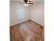 Bedroom featuring hardwood flooring, window, and ceiling fan at 1282 Harris Commons Pl, Roswell, GA 30076