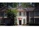 Charming townhome with manicured landscaping and a welcoming front entrance with sidelight windows at 1282 Harris Commons Pl, Roswell, GA 30076
