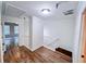 Bright hallway featuring beautiful wood flooring and white trim, leading to another room at 1282 Harris Commons Pl, Roswell, GA 30076