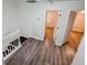 Upstairs hallway featuring wood-look flooring, and neutral paint with doorways leading to other rooms at 1282 Harris Commons Pl, Roswell, GA 30076