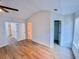 Spacious main bedroom with hardwood flooring, vaulted ceiling, and open doorway to closet at 1282 Harris Commons Pl, Roswell, GA 30076
