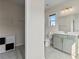 Bright bathroom featuring a modern vanity, clean lines, and a well-organized closet space for optimal functionality at 2076 Holtz Ln, Atlanta, GA 30318