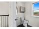 Bathroom showcasing a pedestal sink, toilet, and window with natural light at 2076 Holtz Ln, Atlanta, GA 30318