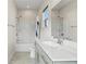 Modern bathroom with a sleek vanity, ample lighting, and a shower-tub combination for a functional and stylish space at 2076 Holtz Ln, Atlanta, GA 30318