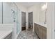 Modern bathroom with a glass shower, tile flooring, and sleek vanity with double sinks at 2076 Holtz Ln, Atlanta, GA 30318