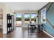 Bedroom or office space with wood floors, a unique accent wall, a balcony, and lots of natural light at 2076 Holtz Ln, Atlanta, GA 30318