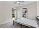 Minimalist bedroom featuring neutral carpet, ceiling fan, and sunlit view at 2076 Holtz Ln, Atlanta, GA 30318