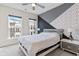 Modern bedroom with stylish accent wall, contemporary furnishings, and ample natural light from large windows at 2076 Holtz Ln, Atlanta, GA 30318