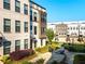 Contemporary townhome featuring a courtyard with outdoor seating and lush landscaping at 2076 Holtz Ln, Atlanta, GA 30318