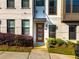 Modern townhome front door with brick facade and tasteful landscaping at 2076 Holtz Ln, Atlanta, GA 30318