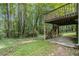 Exterior view of a wooden deck with stairs leading down to the yard full of mature trees at 3420 Cranborne, Marietta, GA 30062
