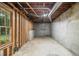 Unfinished basement with concrete floor, exposed ceiling, and natural light from a window at 3420 Cranborne, Marietta, GA 30062