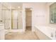 Bathroom featuring a tub, shower, large mirror, and an adjoining walk-in closet at 3420 Cranborne, Marietta, GA 30062