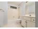 Bathroom featuring a tub-shower, toilet, vanity, and floral striped wallpaper at 3420 Cranborne, Marietta, GA 30062
