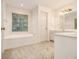 Bathroom with a soaking tub, double sink vanity, and window at 3420 Cranborne, Marietta, GA 30062