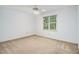 Simple bedroom featuring a ceiling fan, a window overlooking the backyard, white paint, and carpeted floors at 3420 Cranborne, Marietta, GA 30062