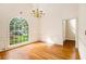 Charming dining room featuring hardwood floors, wainscoting, and a large window at 3420 Cranborne, Marietta, GA 30062