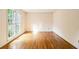 Bright empty room with hardwood floors and a large window overlooking a green lawn at 3420 Cranborne, Marietta, GA 30062